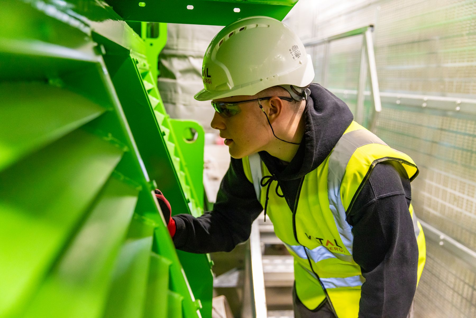 Safety professional inspecting equipment inside an industrial facility